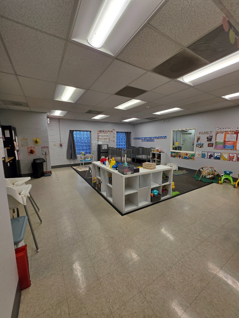 Harwell School Beaverton bright infant and toddler classroom with low storage cubbies and cribs